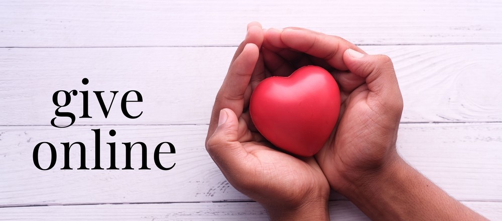 Two hands holding a heart