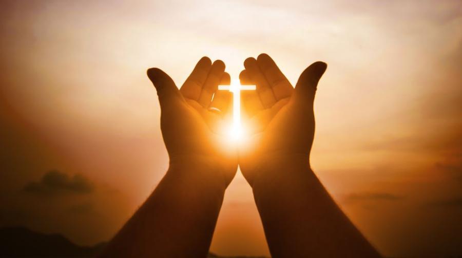 hands with sun and cross