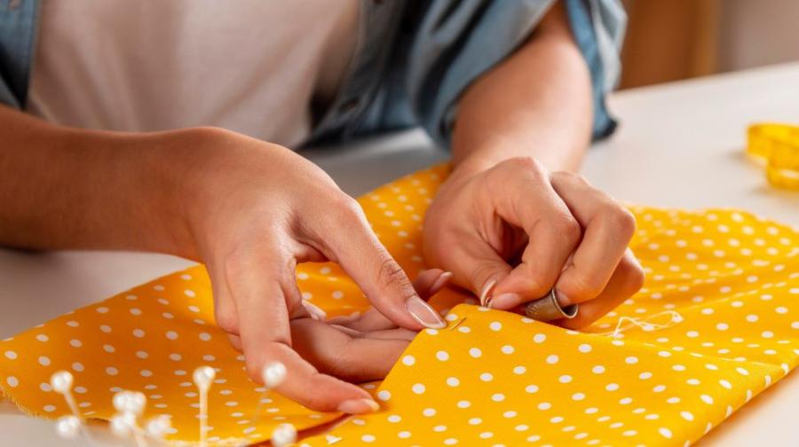 hands and yellow fabric