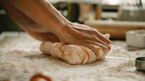 hands kneading bread dough