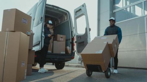 man moving boxes to truck