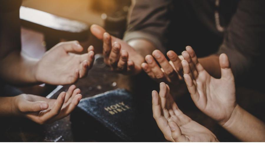 circle of hands in prayer